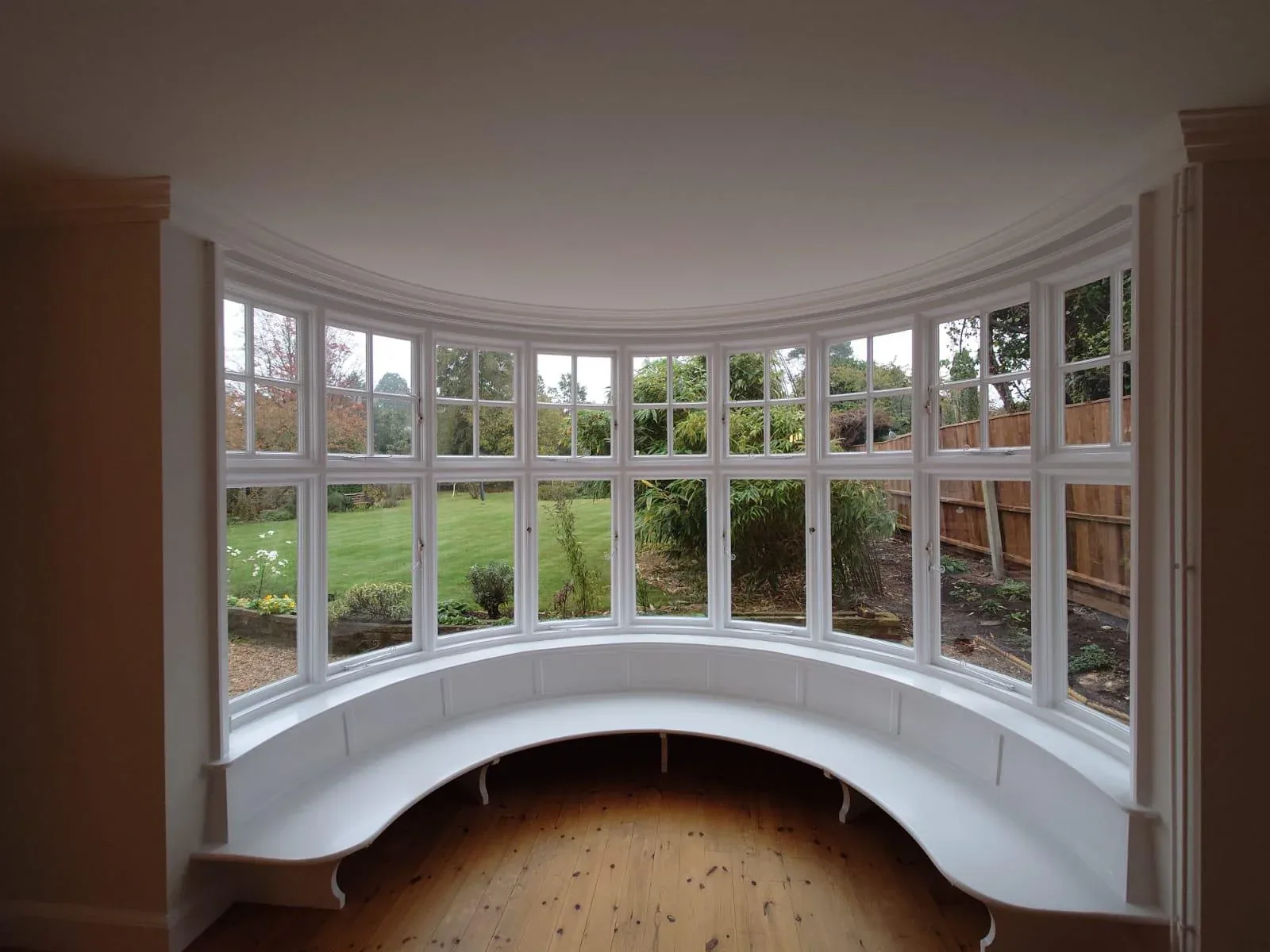 Curved bay window with painted white window seat, frames and woodwork