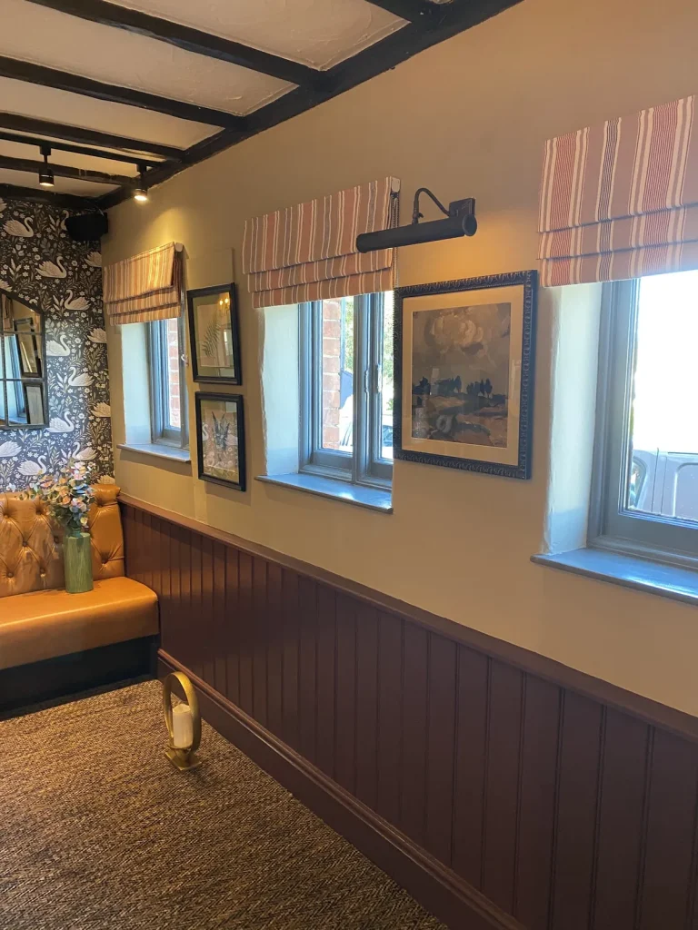 Room with painted panelling, wallpaper and window blinds